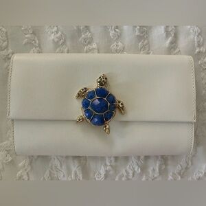 Kate Spade White Clutch with Blue Turtle Accent
Breath of fresh air prima